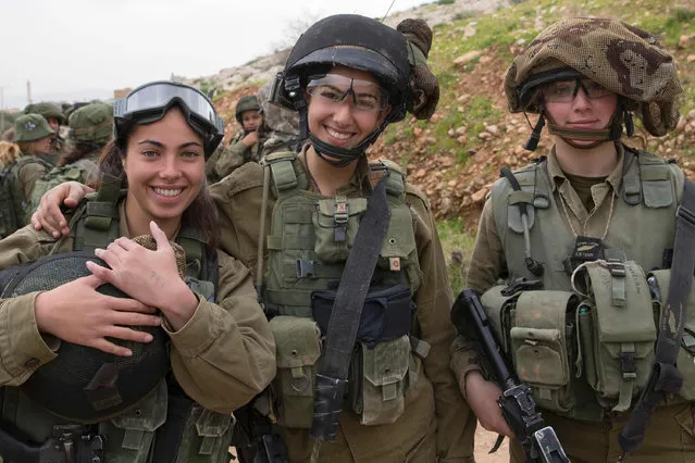 Israeli soldiers from the mixed-gender Lions of the Jordan battalion, under the Kfir Brigade, pose for a photograph during a last training before being assigned their posting, on February 28, 2017, near the West Bank village of Bardale, east of Jenin. (Photo by Jack Guez/AFP Photo)