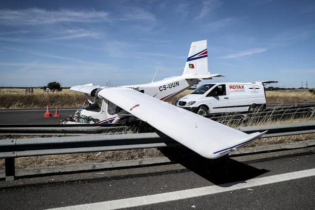 Wreckage of a small plane is pictured after crashing on a highway close to Pinhal Novo, on June 10, 2019. A Pelican style tourist aircraft today made an emergency landing on a highway in the Lisbon area, causing a mild injured, local emergency services said. (Photo by Carlos Costa/AFP Photo)