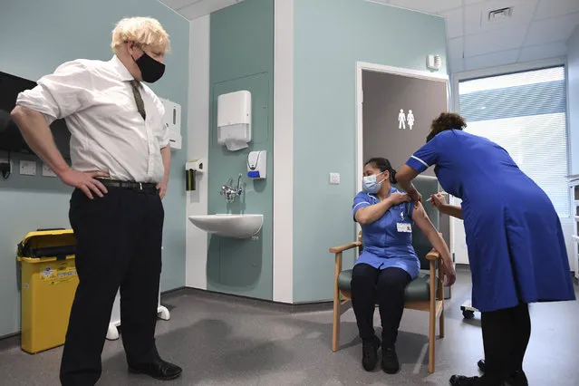 Britain's Prime Minister Boris Johnson watches as nurse Jennifer Dumasi is injected with the Oxford-AstraZeneca Covid-19 vaccine, during a visit to view the vaccination programme at the Chase Farm Hospital in north London, Monday January 4, 2021, part of the Royal Free London NHS Foundation Trust. (Photo by Stefan Rousseau/Pool Photo via AP Photo)