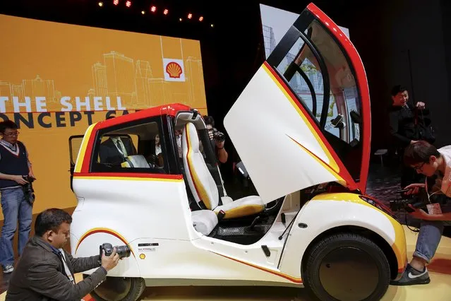 People take pictures of a high-efficiency petrol-burning concept car as it is unveiled by Royal Dutch Shell during a ceremony in Beijing, China April 22, 2016. (Photo by Damir Sagolj/Reuters)