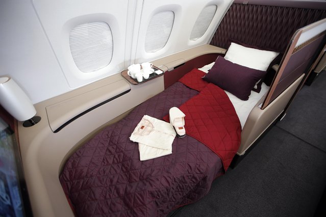 Interior view of the fully lie-flat seat converted into a bed in Premiere (1st) Class in the Airbus A380 of Qatar Airways presented at the Paris Air Show, in Le Bourget airport, north of Paris, Wednesday, June 17, 2015. Qatar Airways has brought 4 Airbus A380's in service since last year. (AP Photo/Francois Mori)