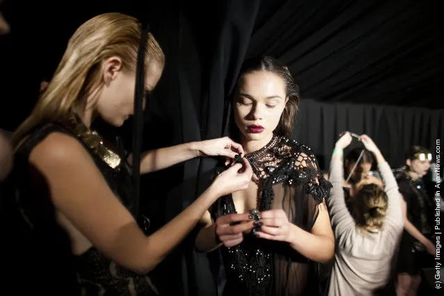 Models prepare backstage before a fashion show by Israeli designer Yossef during the Tel Aviv Fashion Week