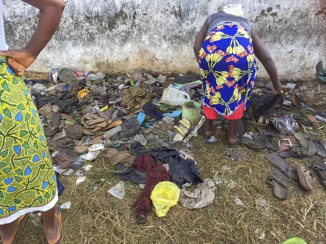 This photograph provided by Augustine D. Wallace shows a woman searching through shoes Thursday January 20, 2022 at the entrance of a field where 29 persons, including 11 children and a pregnant woman have been confirmed killed after they were trampled upon in a stampede at a Christian crusade in New Kru Town, outside Monrovia, Liberia, Wednesday night. The stampede erupted when a group of gangsters, some carrying knives moved on the crusade ground and attacked worshipers. (Photo by Augustine D. Wallace via AP Photo)