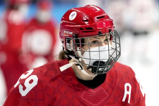 Russian Olympic Committee's Alexandra Vafina wears a COVID mask under her hockey mask as she warms up for a preliminary round women's hockey game against Canada at the 2022 Winter Olympics, Monday, February 7, 2022, in Beijing. (Photo by Petr David Josek/AP Photo)
