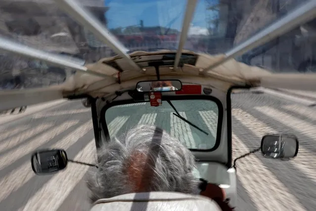 A man rides a tourist tuk tuk amid the coronavirus disease (COVID-19) pandemic in Lisbon, Portugal, May 11, 2021. (Photo by Pedro Nunes/Reuters)