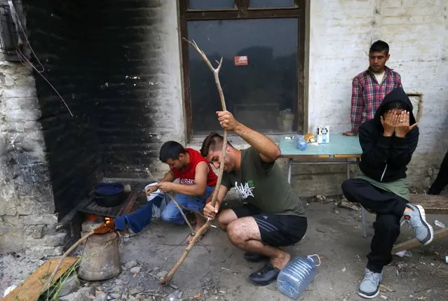 Migrants from Afghanistan gather in an abandoned brick factory in Subotica, Serbia on June 28, 2015, as they prepare to cross the border with Hungary. So far this year nearly 70,000 migrants have crossed into Hungary illegally, most of them coming from Kosovo, Syria and Afghanistan. (Photo by Laszlo Balogh/Reuters)