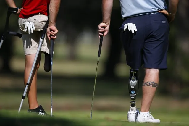Single leg amputees Chad Pfeifer from the US (R) and Juan Postigo from Spain (L) wait to put during the Nedbank South African Disabled Golf Open at Zwartkop Golf Estate, South Africa 03 May 2016. The Nedbank South African Disabled Golf Open is one of the top disabled golf tournaments in the world with more than 60 competitors from various nations competing over the 3 day event. People suffering from any number of physical disabilities including arm and leg amputees, hemiplegics, paraplegics, stroke victims, blind and deaf people that are able to grip the club with at least one hand and hit the ball can compete. (Photo by Nic Bothma/EPA)