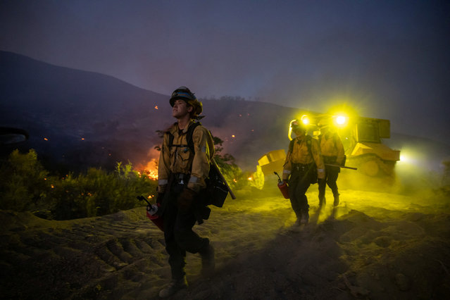 Firefighters battle the Sites fire near Lodoga, California on June 17, 2024. (Photo by Carlos Barria/Reuters)