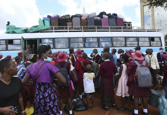 Schooldchildren wait to board the bus to school in Harare, Sunday, February 6, 2022. Zimbabwe schools reopen on Feb. 7 after a weeks long delay in allowing learners back following an upsurge in COVID-19 infections. (Photo by Tsvangirayi Mukwazhi/AP Photo)