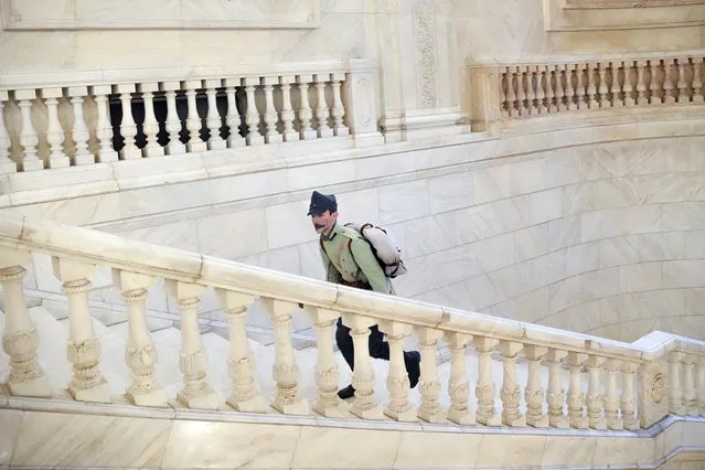 A man wearing a vintage military uniform walks up the stairs at the Palace of the Parliament, the second largest administrative building in the world after the Pentagon, as people took advantage of the opportunity to visit it for free on International Children's Day in Bucharest, Romania, Tuesday, June 1, 2021. More than ten thousand children and adults visited the communist era building, also known as the House of the People, according to the organizers of the event. (Photo by Vadim Ghirda/AP Photo)