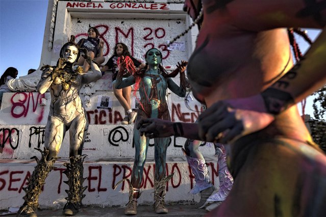 Women of the feminist group called "Nuestros Pilares" perform during a demonstration against gender-based violence on International Women's Day in Santiago, Chile, Wednesday, March 8, 2023. (Photo by Esteban Felix/AP Photo)