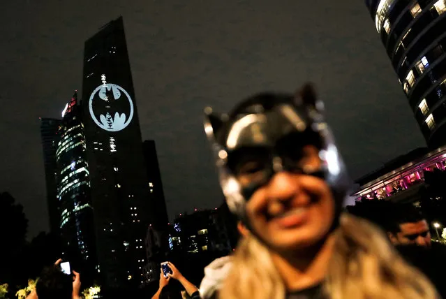 A Bat-Signal is projected onto a building at night as Batman fans celebrate the 80th anniversary of the first appearance of the DC Comics superhero, in Mexico City, Mexico on September 21, 2019. (Photo by Henry Romero/Reuters)