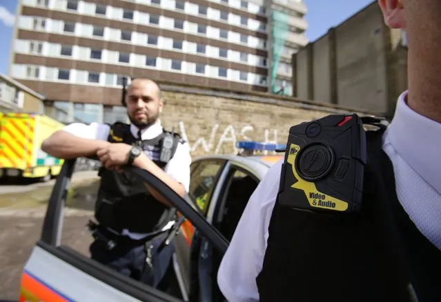 Constable Yasa Amerat (left) and Constable Craig Pearson wearing their body-worn video (BWV) cameras, ahead of a year-long pilot scheme by the Metropolitan police, at Kentish Town in London, on May 6, 2014. (Photo by Yui Mok/PA Wire)