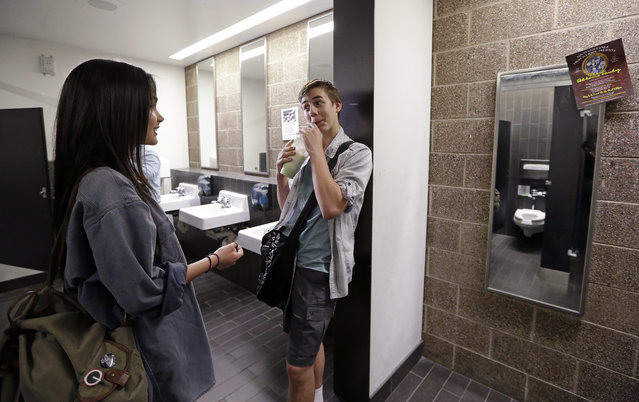 Ninth graders Tehya Vining, left, and Christian Jarboe talk after walking for the first time into a gender neutral bathroom at Nathan Hale high school Tuesday, May 17, 2016, in Seattle. President Obama's directive ordering schools to accommodate transgender students has been controversial in some places but since 2012 Seattle has mandated that transgender students be able to use of the bathrooms and locker rooms of their choice. Nearly half of the district's 15 high schools already have gender neutral bathrooms and one high school has had a transgender bathroom for 20 years. (Photo by Elaine Thompson/AP Photo)