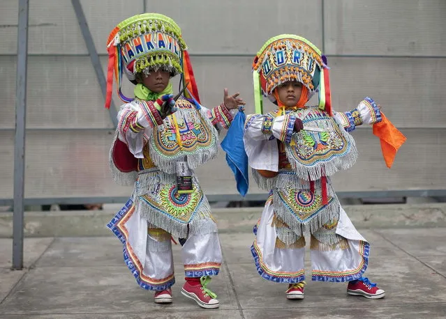 Young “scissors” dancers pose after performing in a national scissors dance competition at Lima's Exposition Park, May 18, 2014. The Danza de las tijeras, or scissors dance, is a traditional dance from the Peruvian southern region of the Andes, in which two or more performers take turns dancing while accompanied with music from a harp and a violin. Dancers would display various skills and moves, which include cutting the air with the use of a scissors. (Photo by Enrique Castro-Mendivil/Reuters)