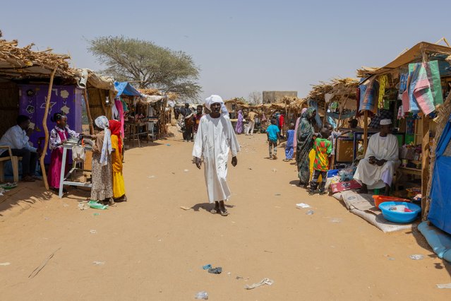 A man walks in the market of the Adre refugee camp, on April 10, 2024. Chad is home to the largest number of Sudanese refugees, nearly a million. In a year since the conflict in Sudan started between two rival factions of the military government, more than 571,000 have rushed there on foot or by mule, adding to more than 400,000 compatriots who fled the previous Darfur war since 2003. (Photo by Joris Bolomey/AFP Photo)