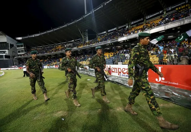 Sri Lanka's Special Task Force soldiers walk towards Pakistan's cricket team's dressing room after the team walked off field after a clash between supporters of the two sides during their third One Day International cricket match against Sri Lanka in Colombo July 19, 2015. (Photo by Dinuka Liyanawatte/Reuters)