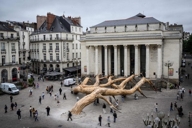 This photograph taken on July 3, 2024, shows the art piece “le Reve de Fitzcarraldo” (Fitzcarraldo's dream) of Brazilian artist Henrique Oliveira displayed in front of the Nantes Opera, downtown Nantes, western France, as part of the “Voyage a Nantes” (VAN) art festival which runs from July 6 to September 8, 2024. (Photo by Loic Venance/AFP Photo)