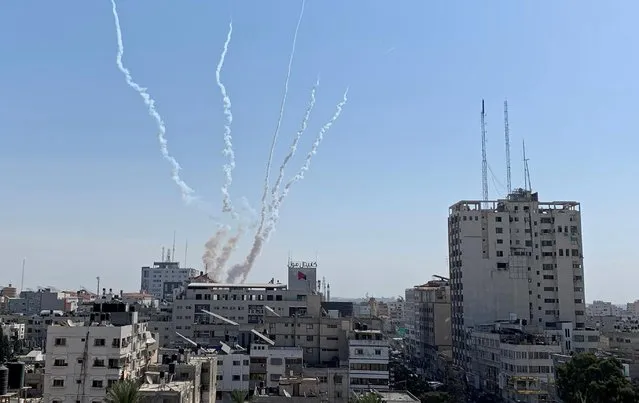 Trails of smoke are seen as rockets are fired from Gaza towards Israel, in Gaza on November 14, 2019. Palestinian militant group Islamic Jihad and Israel declared a halt to hostilities across the Gaza Strip border on Thursday but a lasting ceasefire appeared tenuous as they differed on terms. Islamic Jihad said an Egyptian-mediated truce went into effect at 0330 GMT, about 48 hours after Israel triggered the exchange of fire by killing the Iranian-backed faction's top Gaza commander in an air strike, deeming him an imminent threat. Occasional rocket fire from Gaza and a retaliatory Israeli air strike broke the calm, but the ceasefire largely held. (Photo by Suhaib Salem/Reuters)