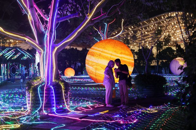 People visit the Galactic Glow playground at Paris Van Java Resort Lifestyle Place in Bandung, West Java province, Indonesia on July 20, 2024. (Photo by Ajeng Dinar Ulfiana/Reuters)