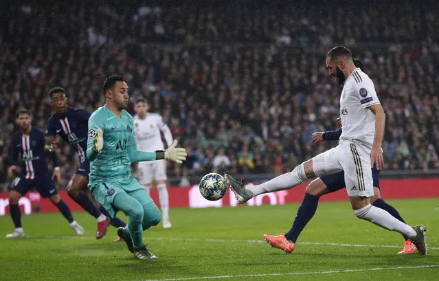 PSG's goalkeeper Keylor Navas, left, makes a save against Real Madrid's Karim Benzema during a Champions League soccer match Group A between Real Madrid and Paris Saint Germain at the Santiago Bernabeu stadium in Madrid, Spain, Tuesday, November 26, 2019. (Photo by Manu Fernandez/AP Photo)