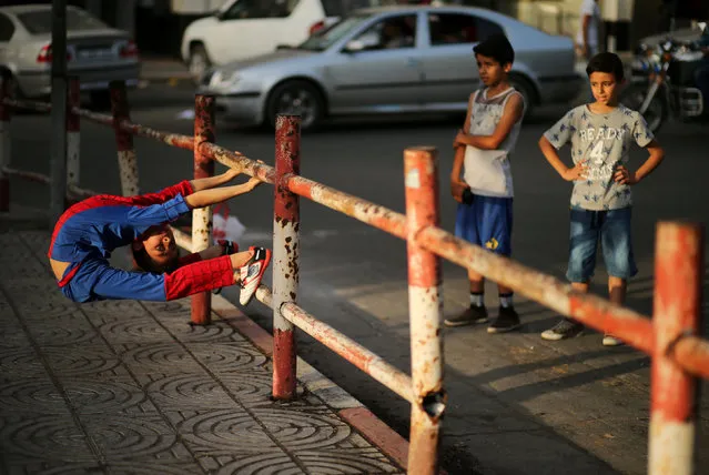 Palestinian boy Mohamad al-Sheikh, 12, who is nicknamed “Spiderman” and hopes to break the Guinness world records with his bizarre feats of contortion, demonstrates acrobatics skills in Gaza City June 2, 2016. (Photo by Mohammed Salem/Reuters)
