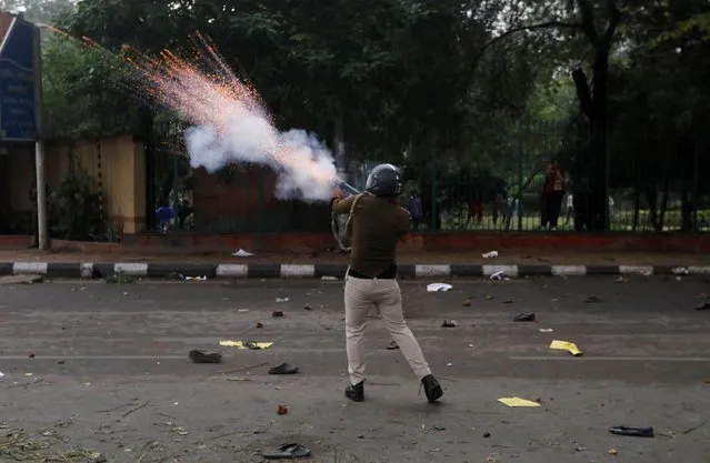 A police officer fires a teargas shell towards students during a protest against the Citizenship Amendment Bill, a bill that seeks to give citizenship to religious minorities persecuted in neighbouring Muslim countries, outside the Jamia Millia Islamia University in New Delhi, December 13, 2019. (Photo by Adnan Abidi/Reuters)