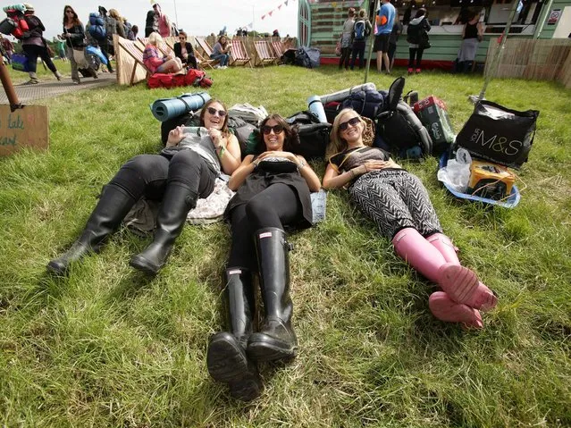 Festival goers (L to R) Liz, Lauren and Hannah, all from London, relax upon arriving for the Glastonbury Festival, at Worthy Farm in Somerset. (Photo by Yui Mok/PA Wire)