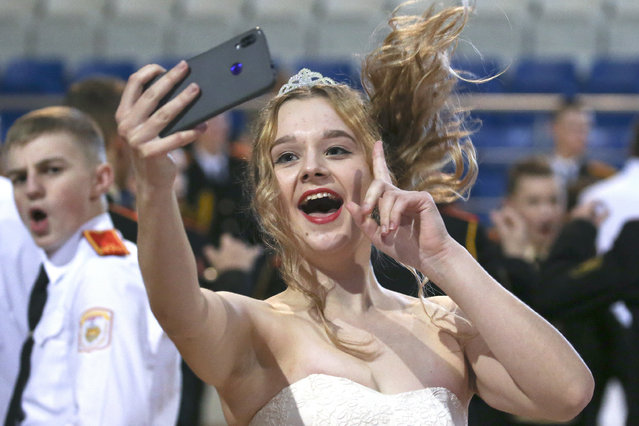 A young girl makes a selfie during the 4th New Year Republican Suvorov Cadet Ball at the Uruchie Sports Palace in Minsk, Belarus on December 23, 2019. (Photo by Natalia Fedosenko/TASS)