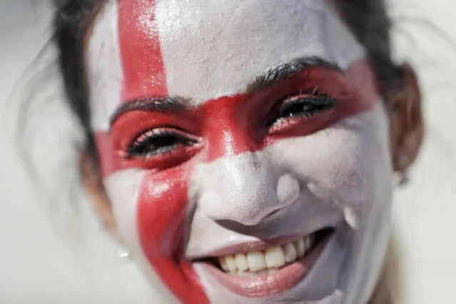An English soccer fan smiles as she enters the Velodrome stadium ahead of the Euro 2016 Group B soccer match between England and Russia,  in Marseille, France, Saturday, June 11, 2016. (Photo by Ariel Schalit/AP Photo)