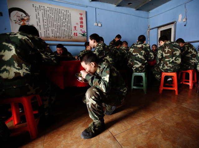 Students eat a meal at the Qide Education Center in Beijing February 19, 2014. The Qide Education Center is a military-style boot camp which offers treatment for internet addiction. As growing numbers of young people in China immerse themselves in the cyber world, spending hours playing games online, worried parents are increasingly turning to boot camps to crush addiction. (Photo by Kim Kyung-Hoon/Reuters)