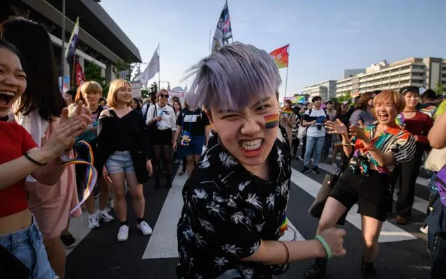 Participants dance as they march during a Pride event in support of LGBT rights in Seoul on June 1, 2019. Tens of thousands of gay rights supporters paraded through central Seoul despite South Korea's main conservative opposition party denouncing the Pride event in a country where Christian churches have enduring political influence. (Photo by Ed Jones/AFP Photo)