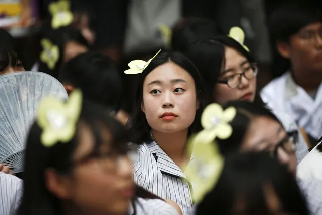 School girls wearing hairpins in the shape of a butterfly take part in the weekly Wednesday protest in front of the Japanese embassy demanding for an apology and compensation from Japanese government in Seoul, South Korea, July 22, 2015. The butterfly is a symbol of the Butterfly Fund, which helps women across the world affected by wartime sexual violence. (Photo by Kim Kyung-Hoon/Reuters)