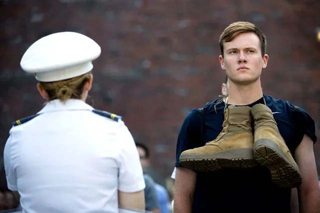 A cadet candidate (R) receives orders from older cadets during the in-processing procedures during Reception Day at the United States Military Academy at West Point, June 27, 2016 in West Point, New York. Reception Day is the day when new cadets report to West Point to begin the process of becoming West Point cadets and future U.S. Army officers. Upwards of 1,300 cadet candidates for the class of 2020 will report to West Point on Monday. The new cadets will begin six weeks of basic training before Acceptance Day in early August. (Photo by Drew Angerer/AFP Photo)