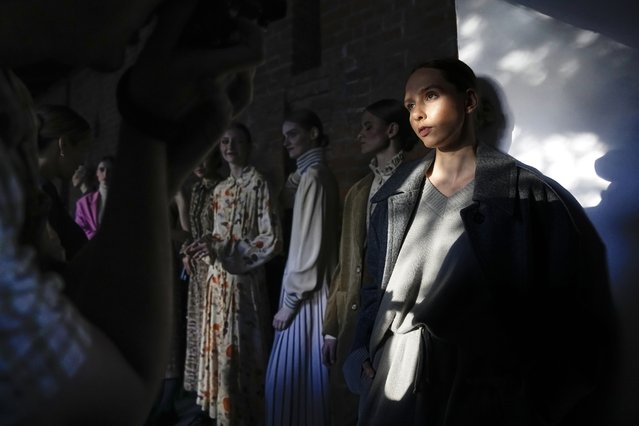 Models stand backstage waiting to display the collection “Loom by Rodina” by Russian designer Svetlana Rodina at the historical Kitai-Gorod (China Town) Wall during the Fashion Week at Zaryadye Park near Red Square in Moscow, Russia, Wednesday, June 22, 2022. (Photo by Alexander Zemlianichenko/AP Photo)