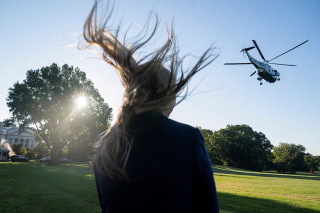 A member of the U.S. Secret Service looks on as Marine One carrying President Joe Biden departs from the South Lawn of the White House in Washington, on October 17, 2024. (Photo by Nathan Howard/Reuters)