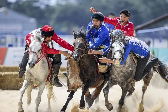 Teams compete in Buzkashi at the 5th Etnospor Culture Festival held at Ataturk Airport, in Istanbul, Turkiye on June 10, 2022. Buzkashi or kokpar is the Central Asian sport in which horse-mounted players attempt to drag a goat or calf carcass toward a goal. (Photo by Arife Karakum/Anadolu Agency via Getty Images)