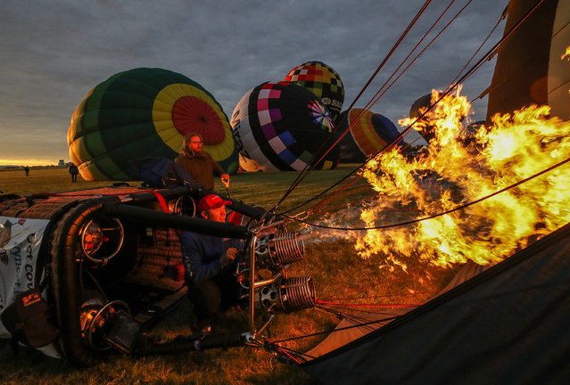 Crews prepare hot air balloons for the Kentucky Derby Festival Great Balloonfest Rush Hour Race at Bowman Field on Friday, April 26, 2024. (Photo by Michael Clevenger/Courier Journal)