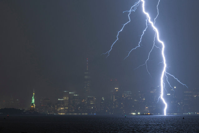 Lightning strikes the water to the the right of One World Trade Center with midtown and lower Manhattan in the background in New York City on July 17, 2024. (Photo by Craig T Fruchtman/Getty Images)