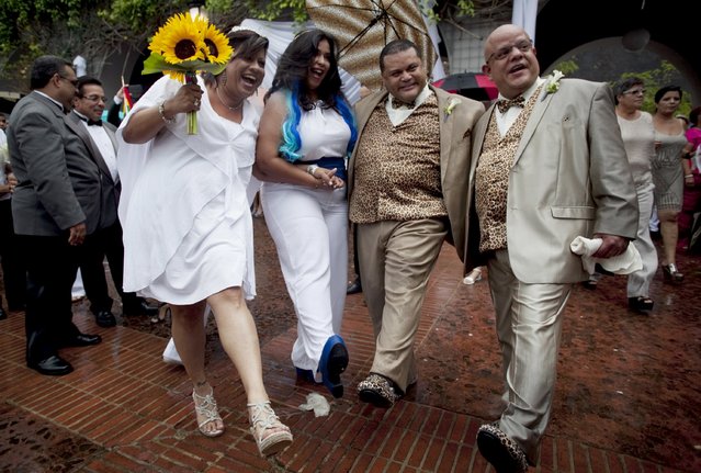 Two same-s*x couples celebrate after their weddings in San Juan, Puerto Rico, August 16, 2015. Some 60 couples wed in a mass ceremony in celebration of the June 2015 U.S. Supreme Court ruling that the U.S. Constitution provides same-s*x couples the right to marry, according to local media. (Photo by Alvin Baez/Reuters)