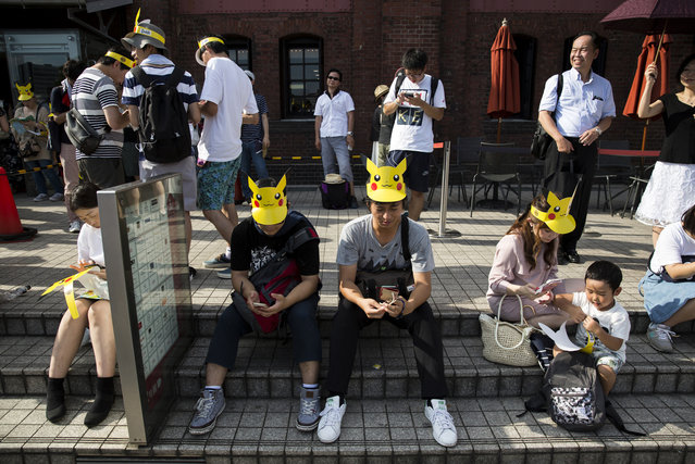 People play Nintendo Co.'s Pokemon Go augmented reality game on their smartphones during the Pikachu Outbreak event hosted by The Pokemon Co. on August 9, 2017 in Yokohama, Kanagawa, Japan. (Photo by Tomohiro Ohsumi/Getty Images)