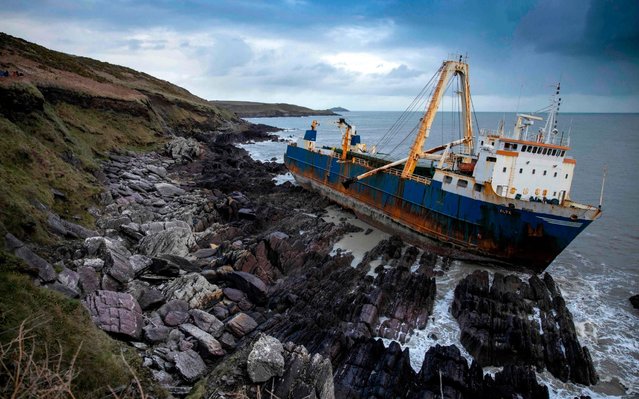 The abandoned 77-metre (250-feet) cargo ship MV Alta is pictured stuck on rocks near the village of Ballycotton south-east of Cork in Southern Ireland on February 18, 2020. A “ghost ship” drifting without a crew for more than a year washed ashore on Ireland's south coast in high seas caused by Storm Dennis, the Republic's coast guard said. (Photo by Cathal Noonan/AFP Photo)