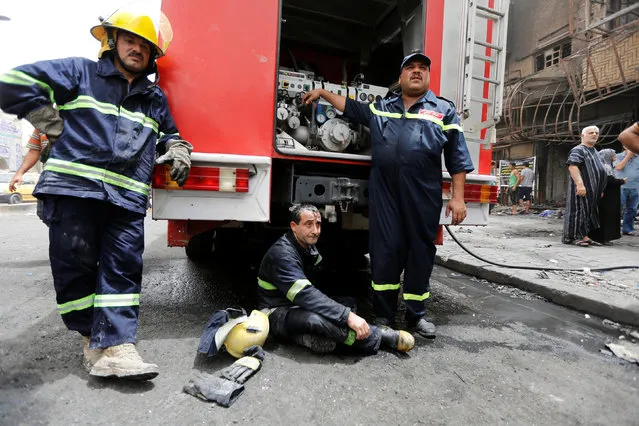 Firemen resting at the site after a suicide car bomb attack at the shopping area of Karrada, a largely Shi'ite district, in Baghdad, Iraq July 4, 2016. (Photo by Ahmed Saad/Reuters)