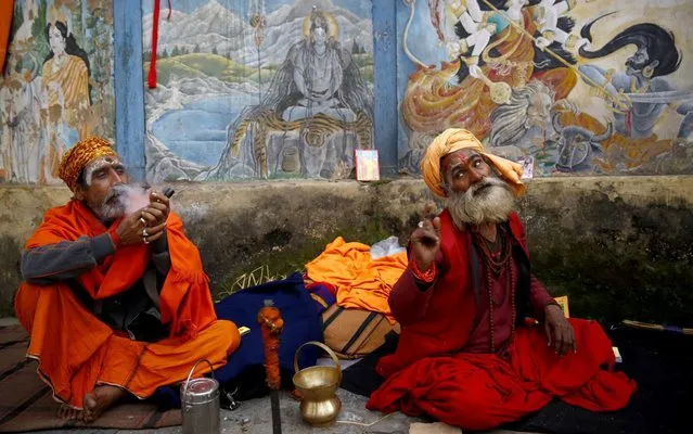 A Sadhu smokes marijuana from a chillum as another Sadhu waits for his turn inside the Pashupathinath Temple in Kathmandu, Nepal on February 19, 2020. With only a few days left for the Maha Shivaratri festival Sadhus from all over India and Nepal have gradually started to arrive at the temple premise for the celebration. (Photo by Prabin Ranabhat/Pacific Press via ZUMA Wire/Rex Features/Shutterstock)