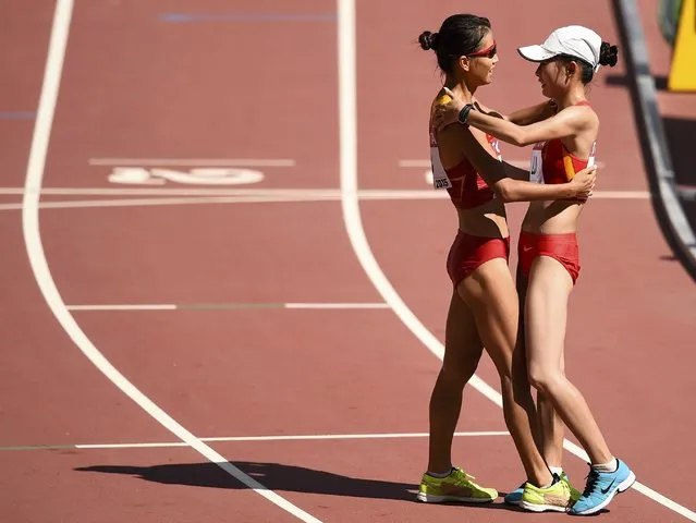 Liu Hong of China (L) celebrates with Lu Xiuzhi of China after winning the women's 20 km race walk final during the 15th IAAF World Championships at the National Stadium in Beijing, China August 28, 2015. (Photo by Dylan Martinez/Reuters)