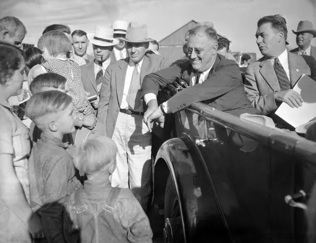 President Franklin Roosevelt, getting drought information first-hand in his car as he talked with farmer Will Duerr and his family in Julesburg, Colo. on September 3, 1936. (Photo by AP Photo)