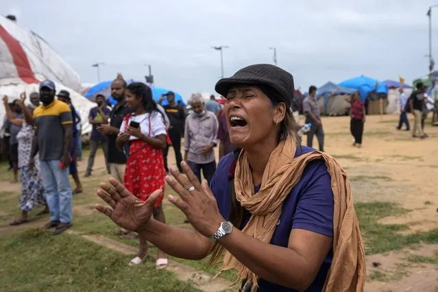 A woman reacts to a police announcement aired using loudspeakers ordering protesters to vacate the site of months long anti government protests outside the president's office in Colombo, Sri Lanka, Thursday, August 4, 2022. (Photo by Eranga Jayawardena/AP Photo)