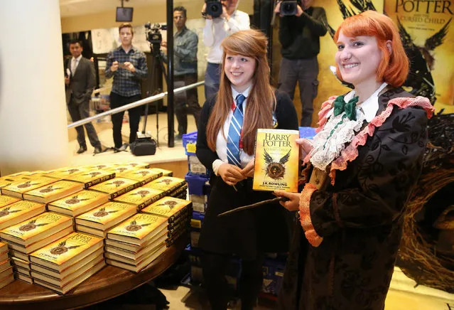 Competition winner Fran Plagge (R) is the first to receive a copy of the book of the play of Harry Potter and the Cursed Child parts One and Two at a bookstore in London, Britain July 31, 2016. (Photo by Neil Hall/Reuters)