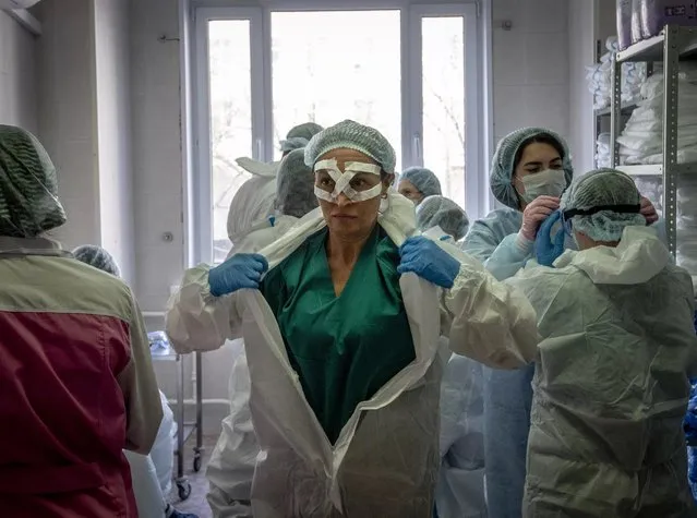 Medical workers get ready for a shift treating coronavirus patients at the Spasokukotsky clinical hospital in Moscow on April 22, 2020. (Photo by Yuri Kadobnov/AFP Photo)