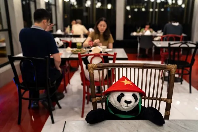 People have dinner as they sit next to stuffed panda dolls, used as part of social distancing measures to prevent the spread of the coronavirus disease (COVID-19), at the Maison Saigon restaurant that reopened after the easing of restrictions in Bangkok, Thailand, May 13, 2020. (Photo by Athit Perawongmetha/Reuters)